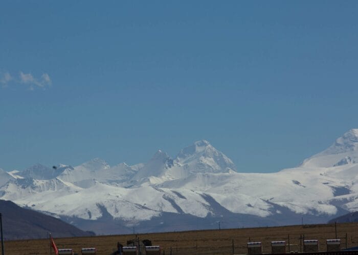 Snow-capped mountains under clear blue sky