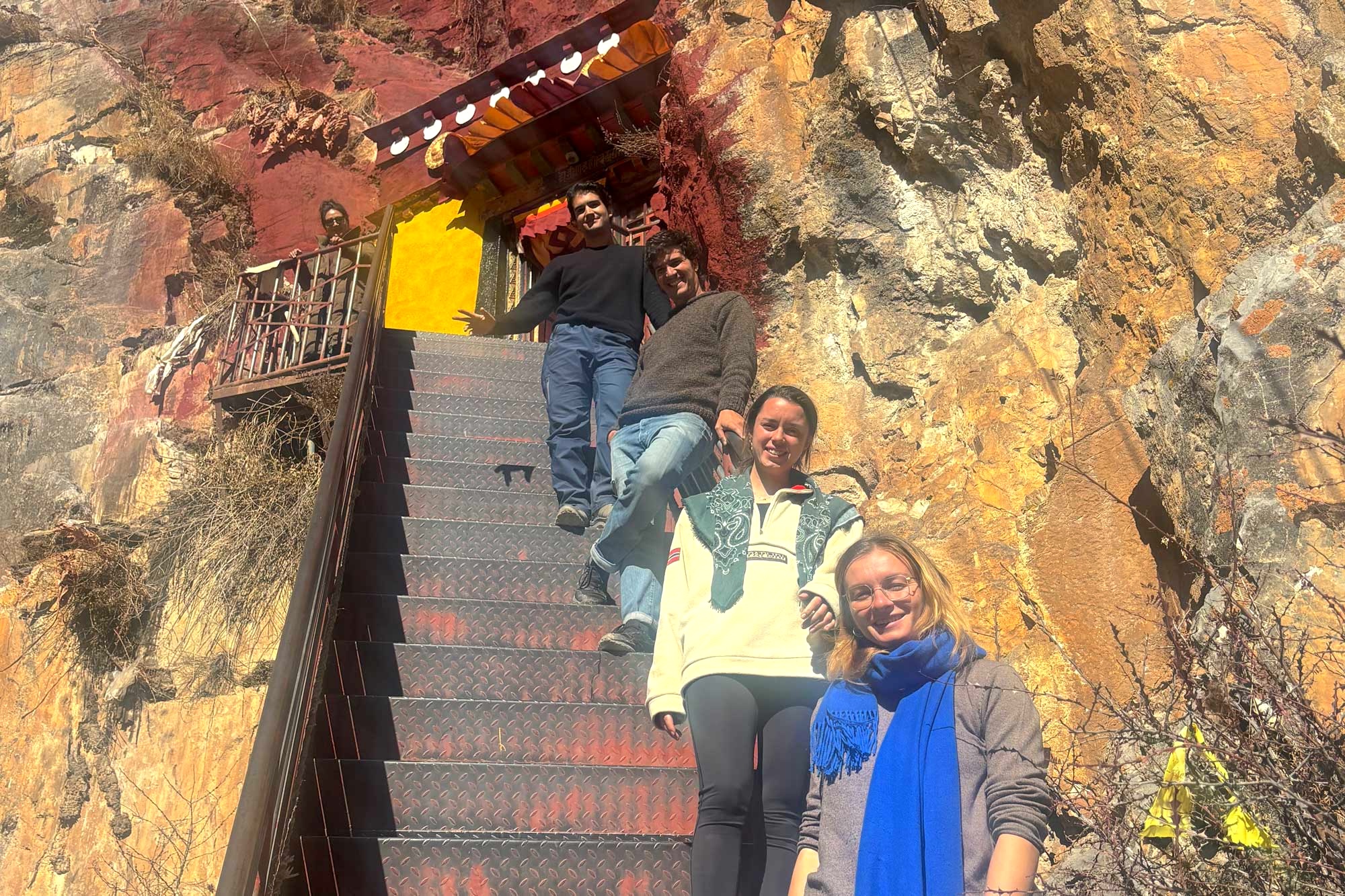 Our French group smiling on the stairs of Drak Yerpa meditation caves.